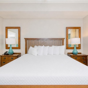 Relax in this inviting master bedroom featuring a plush king bed, stylish decor, and soothing natural light