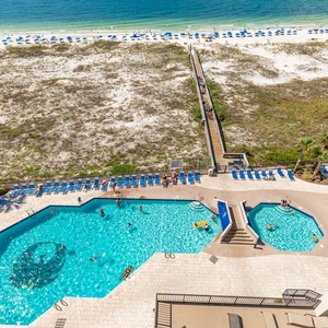 Dive into relaxation at the inviting pool area, surrounded by lounge chairs and just steps from the beach access