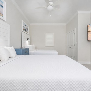 Guests will sleep peacefully in this stylish queen suite after a day of beach activities