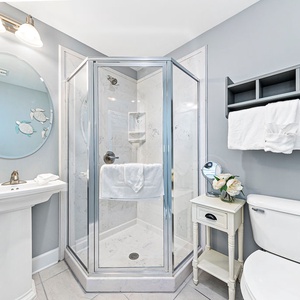 Rinse in the corner shower enclosure in this elegant guest bath