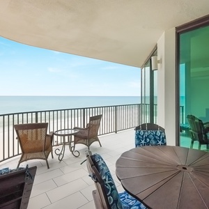 Enjoy meals or drinks on the spacious balcony, featuring comfortable seating and beautiful views of the water