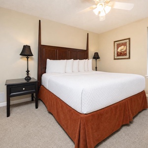 Unwind in the inviting bedroom featuring a plush king bed, soft lighting, and tasteful decor for a restful stay