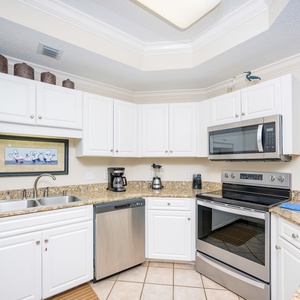 Prepare meals in this kitchen with sleek cabinetry, stainless appliances, and spacious countertops