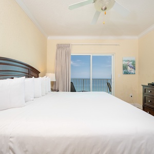 Beachfront master bedroom featuring a king bed and a balcony with breathtaking views of the sparkling waters