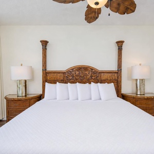 Quiet comfort surrounds you in the master suite with a charming carved headboard and gentle ambient lighting