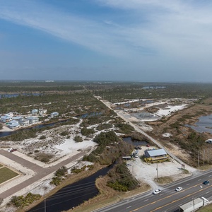 This view showcases serene landscapes with waterways and charming homes, perfect for a peaceful getaway