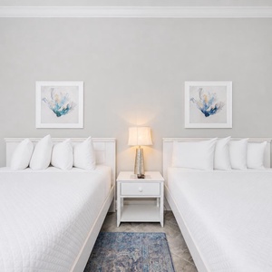Relax on one of the cozy queen beds in this guest suite and admire the subtle accents for a soothing stay