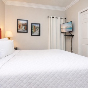 Relax in the master bedroom, where soft bedding and charming decor create the perfect retreat