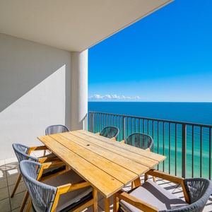 Relax at your balcony's rustic dining table, taking in breathtaking coastal views while enjoying refreshing drinks