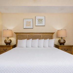 Experience serene nights in the master suite, surrounded by soft bedding and cozy lamps, perfect for restful sleep