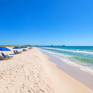 Experience tranquil beach views with soft waves lapping at the sandy shore, perfect for relaxation and seaside strolls