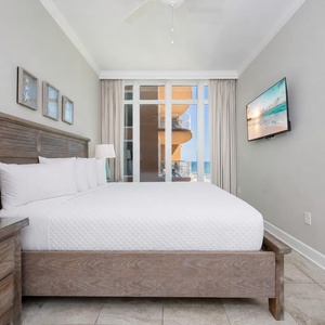 Drift to sleep on the king guest suite as gulf light filters through the floor-to-ceiling glass windows