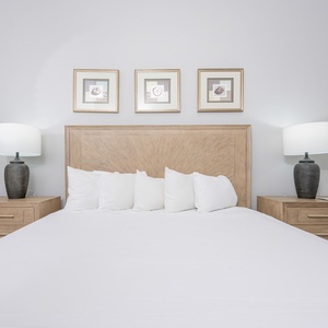 Relax in this inviting guest bedroom featuring a plush king bed, stylish decor, and soft lighting for a cozy ambiance