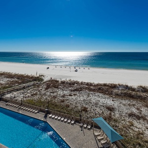 Take a refreshing dip in the pool while enjoying views of the shoreline and sparkling water just steps away