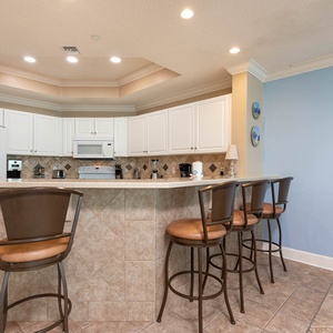 Wake up with morning coffee at the breakfast bar and get ready for a beach day in this stylish space