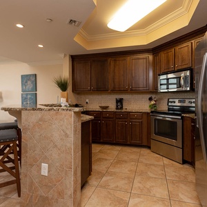 This kitchen features stainless appliances, granite countertops, and a bar area, perfect for casual dining and entertaining