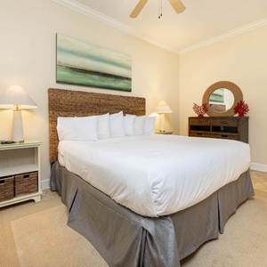 Relax in this peaceful guest bedroom featuring a cozy king bed, soft lighting, and coastal decor for a tranquil retreat
