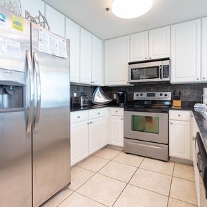 The kitchen offers plentiful appliances, a Kuerig, granite countertops, and ample cabinetry for delightful cooking adventures