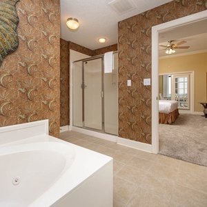 Indulge in relaxation in the master bath with a refreshing walk-in shower and soothing jetted tub
