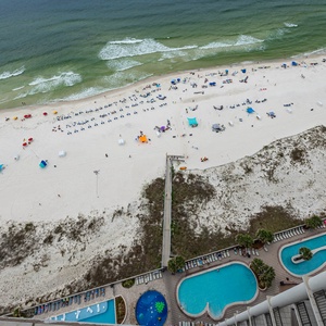 Experience stunning beachfront views alongside inviting pools from this stylish balcony, perfect for relaxation and leisure