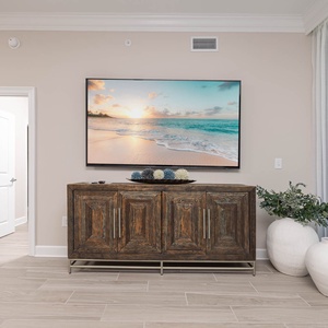 Relax in the stylish living area, featuring a large TV and decorative accents that enhance your comfort and enjoyment