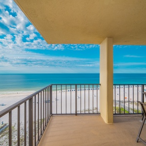 Serene view of the beach front, with white sand and a clear blue sky enhancing the relaxing atmosphere