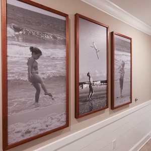 Appreciate the playful beach-themed art that sparks fond memories and invites joyful moments in your coastal retreat