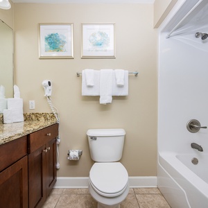 Refresh in the stylish guest bathroom featuring a granite countertop, elegant decor, and a relaxing shower-tub combo