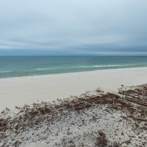 Gaze at the serene waters and expansive shoreline, perfect for relaxation and beachside strolls