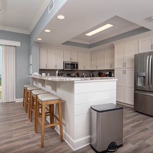 Sip your morning coffee at the breakfast bar and get ready for a beach day in this stylish space