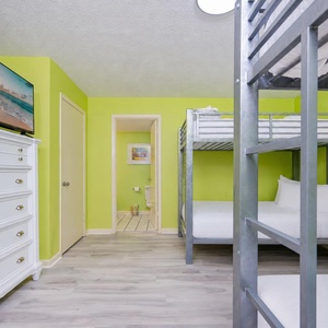 Cozy up with the family in this cheerful twin over full bunk room, perfect for movie nights on the large TV