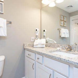 Freshen up in this guest bath in the relaxing shower or soothing tub before an exciting beach day