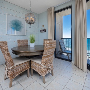 Dine at the round table while enjoying the beachfront view through the sliding glass balcony doors