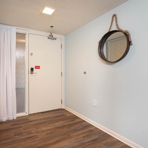 Step into a welcoming entryway featuring a round mirror, stylish decor, and easy access to your vacation retreat