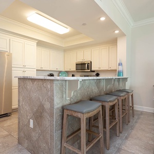 Sip your morning coffee at the breakfast bar and get ready for a beach day in this stylish space