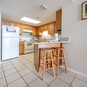 Cook and gather at the kitchen featuring wooden cabinetry and ample counter space for meal prep