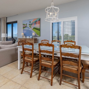 Gather around the spacious dining table, perfect for meals and games, with natural light streaming through the windows
