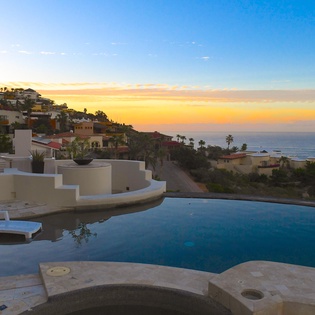 Patio with ocean view during sunset