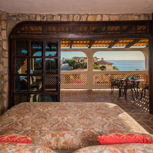 Suite with king bed and pocket doors to terrace