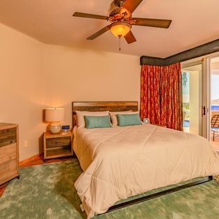 Suite with king bed and door to patio
