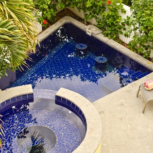 Patio with lounge chairs, pool and jacuzzi