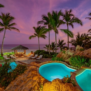 Gorgeous patio with pool and beach view during sunset