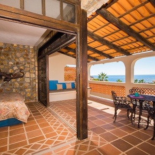 Suite with king bed and pocket doors to terrace