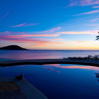 Pool with ocean view during sunset