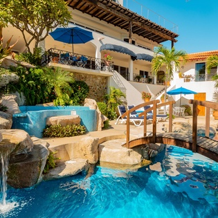 Patio with infinity pool and walkway bridge