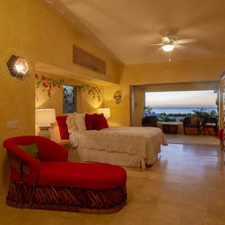 Bedroom suite with patio access and ocean views