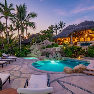 Poolside view of patio during sunset