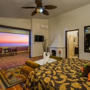 Suite with king bed and pocket doors to terrace