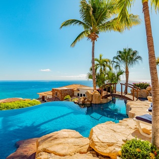 Patio with infinity edge pool and ocean view
