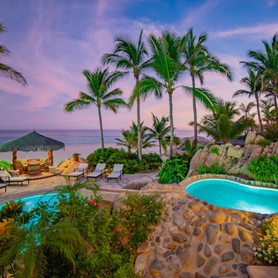 Patio with pool and beachfront view